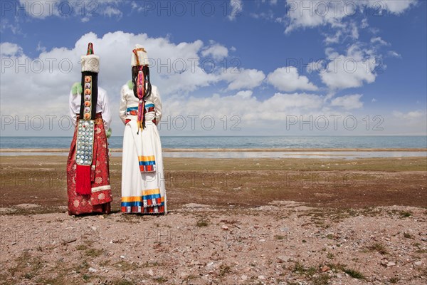 Rear view of women in traditional clothing in remote landscape