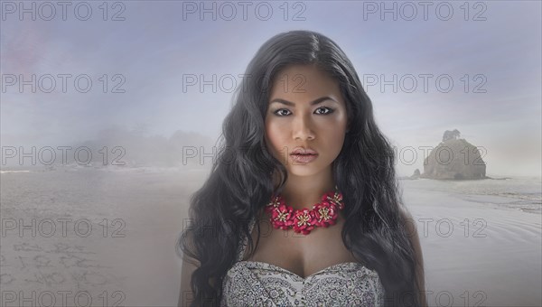 Serious Asian woman on beach