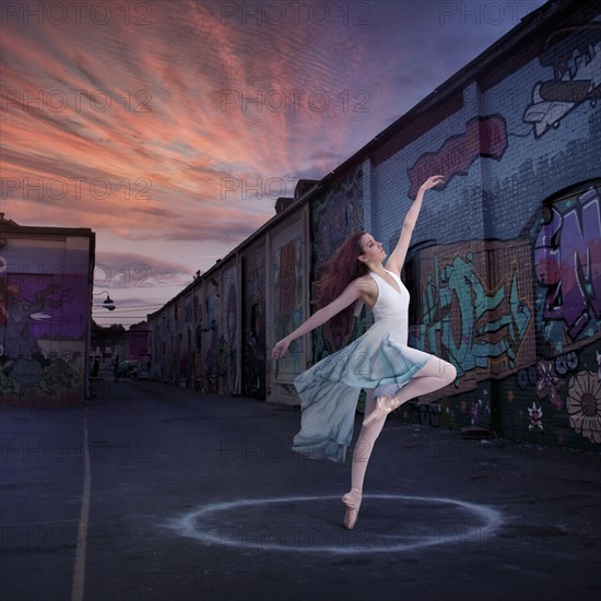 Caucasian ballerina dancing in circle