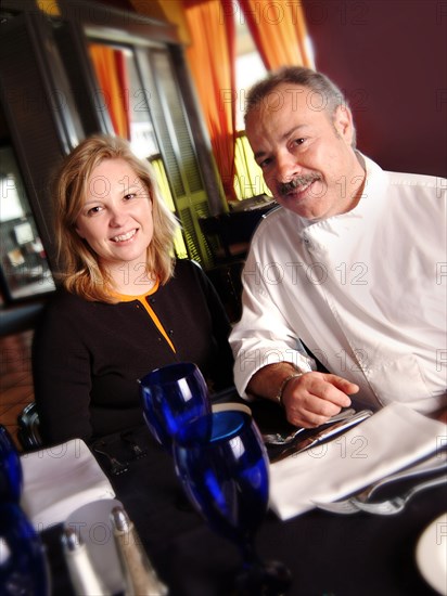 Chef and restaurant owner smiling