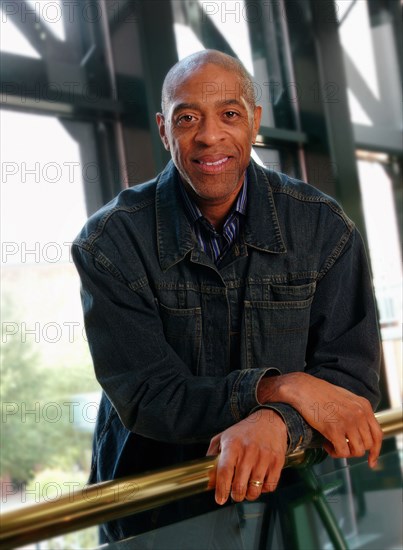 Smiling man leaning on banister