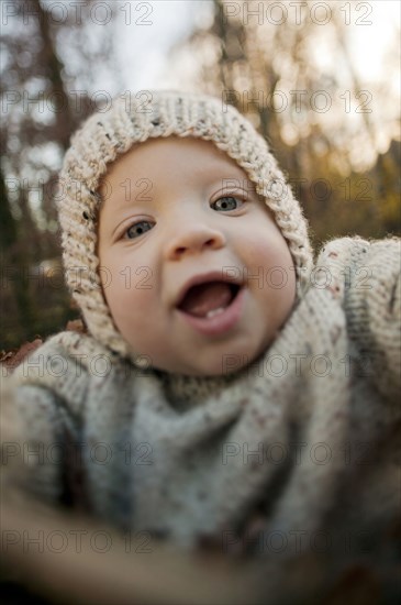 Close up of baby boy smiling outdoors