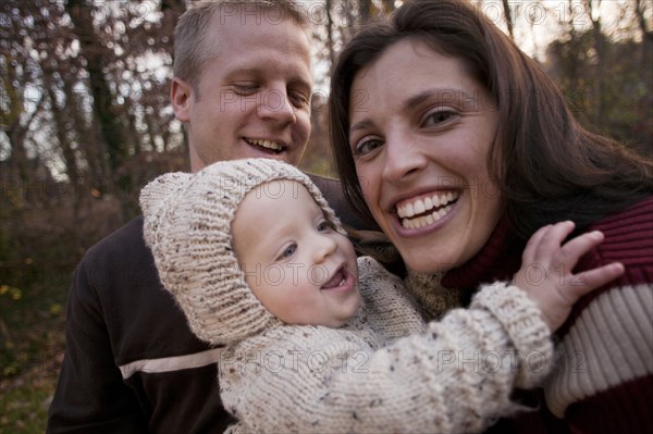 Family laughing outdoors