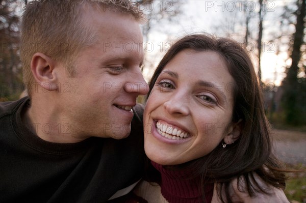 Smiling couple hugging outdoors