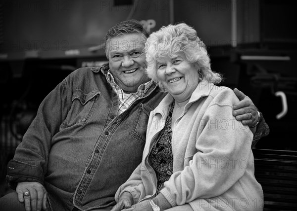 Older Caucasian couple hugging outdoors