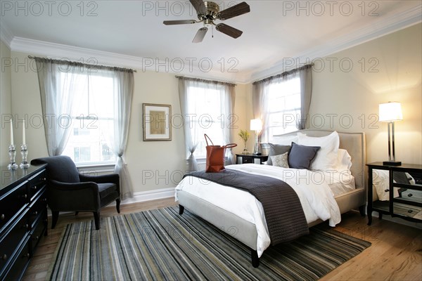 Bed and armchair in modern bedroom