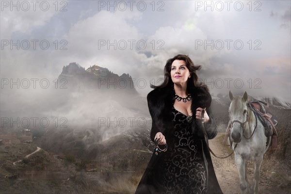 Caucasian woman walking horse in remote landscape