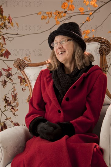 Caucasian woman sitting in armchair outdoors