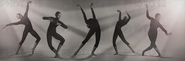 Multiple exposure of Mixed Race woman dancing