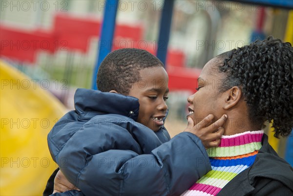 Smiling mother carrying son