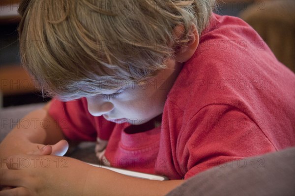 Caucasian boy watching cell phone