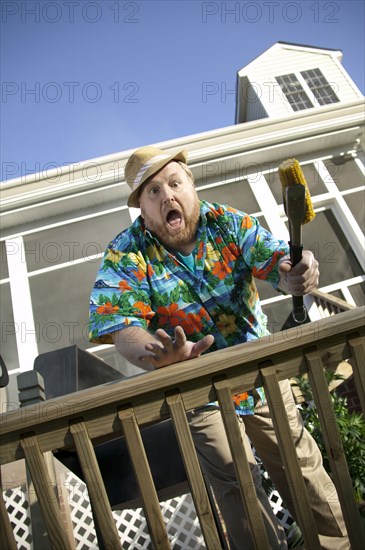 Surprised man  barbecuing on patio