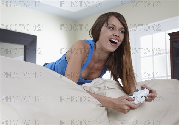 Mixed race woman playing video game