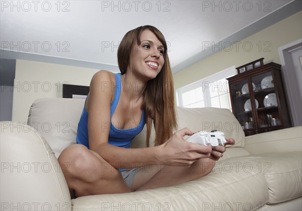 Mixed race woman playing video game