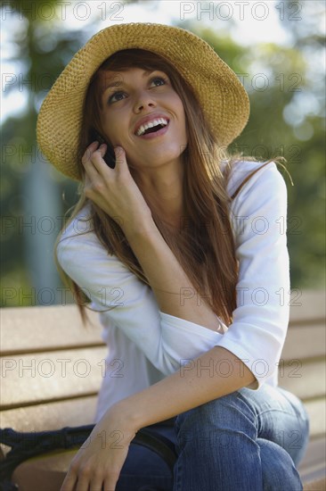 Mixed race woman talking on cell phone outdoors