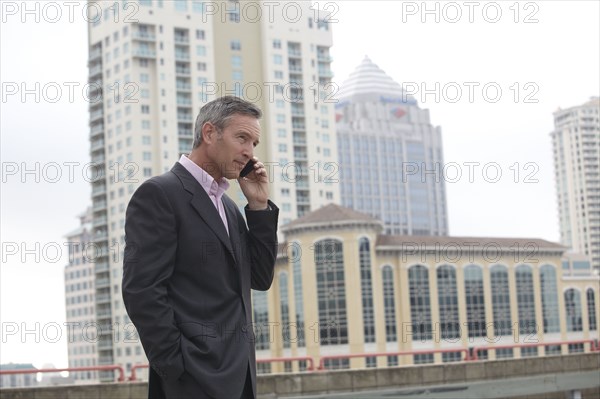 Caucasian businessman talking on cell phone