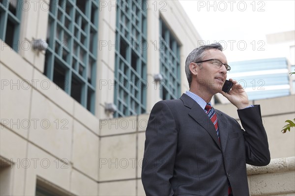 Caucasian businessman talking on cell phone