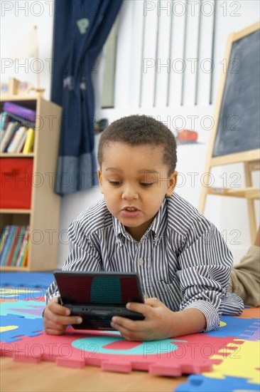 Mixed race boy playing video game