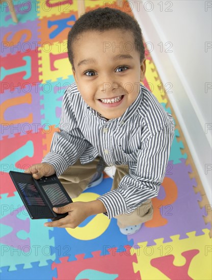 Mixed race boy playing video game