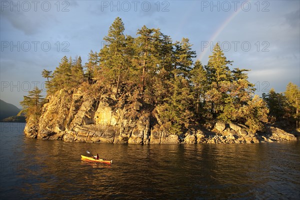 Hispanic woman kayaking on lake