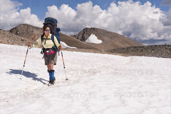 Hispanic woman hiking over snow