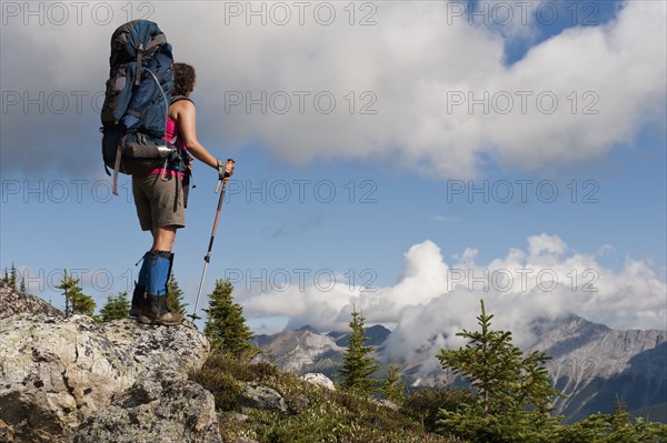 Hispanic woman hiking near mountain