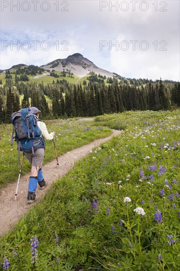 Hispanic woman hiking near mountain