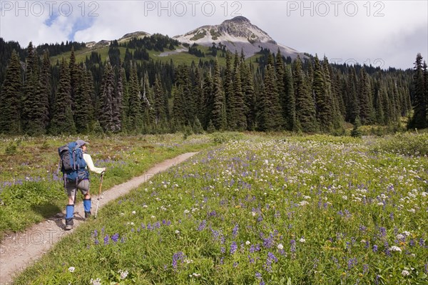 Hispanic woman hiking near mountain