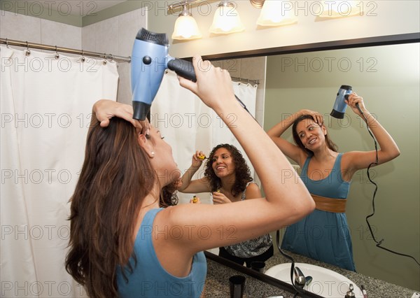 Hispanic women preparing for girl's night out