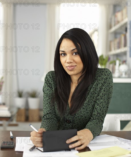 Woman writing in checkbook