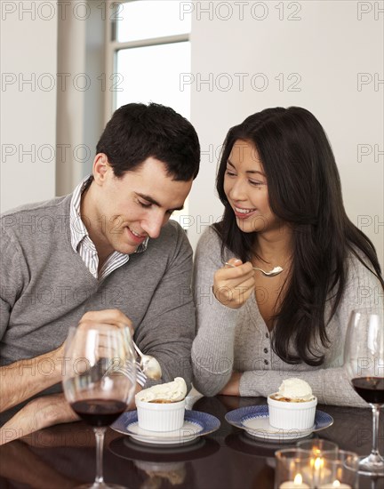 Couple eating dessert together