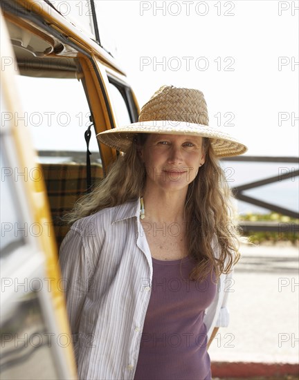 Caucasian woman standing in doorway of camper