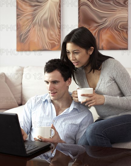 Couple looking at laptop together