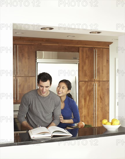 Couple cooking together in kitchen