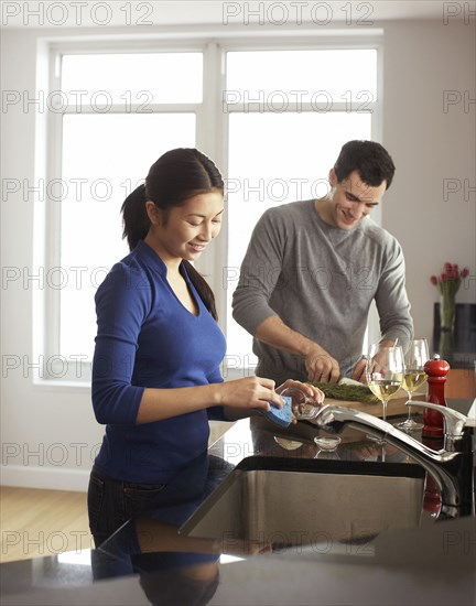 Couple cooking together in kitchen