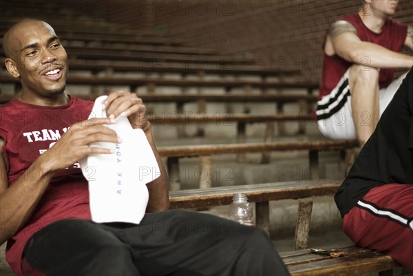 Basketball players sitting in bleachers