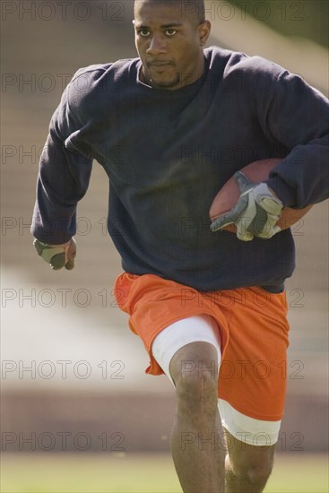 Man running with football