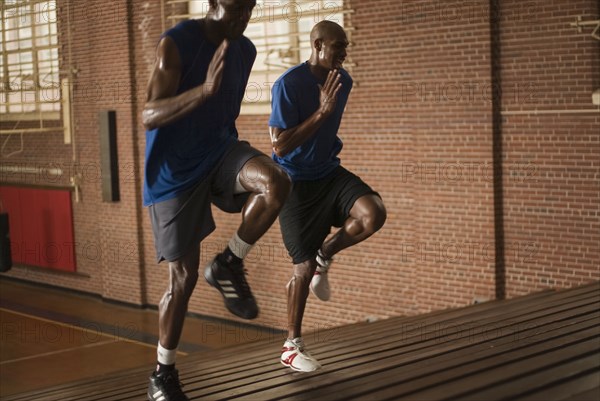 Basketball players running on bleachers