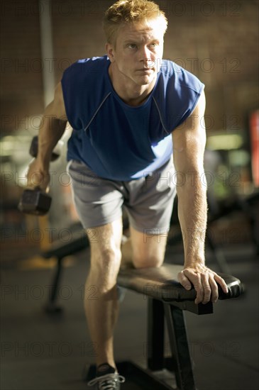 Man lifting weights in health club