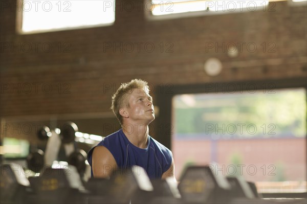 Man lifting weights in health club