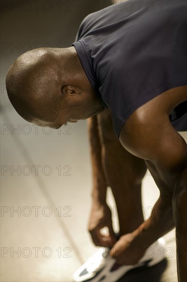 Man tying his shoes