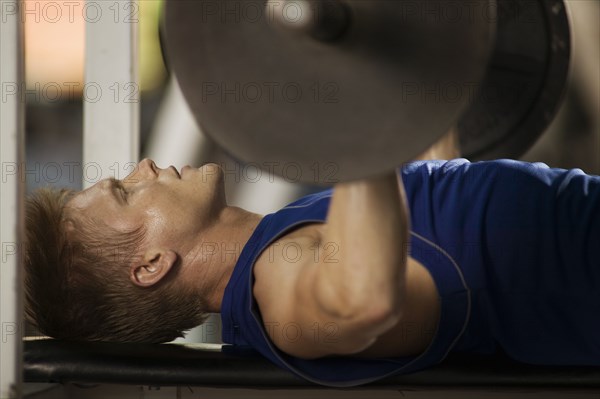 Man lifting weights in health club