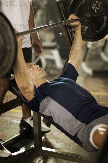 Man lifting weights in health club