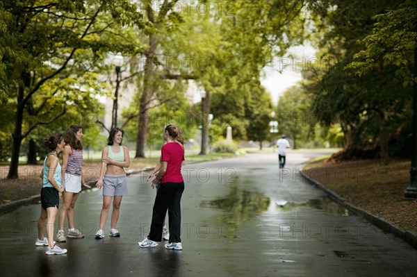 Runners talking in park