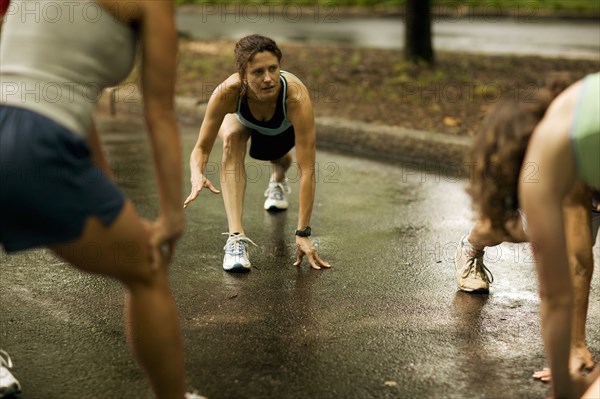 Runners stretching in park