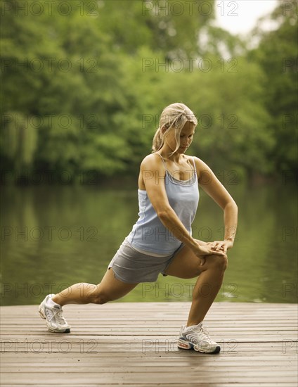 Woman stretching on pier