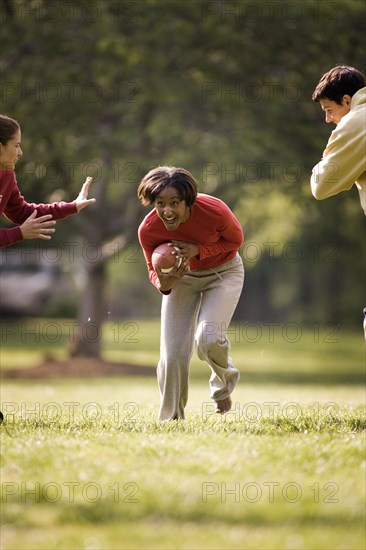 Friends playing football in park