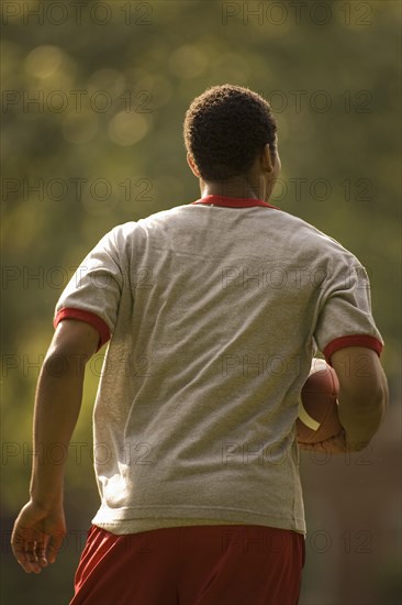 Man running with football