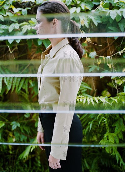 Woman behind window in greenhouse