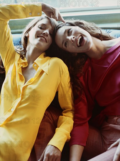 Playful Caucasian women sitting